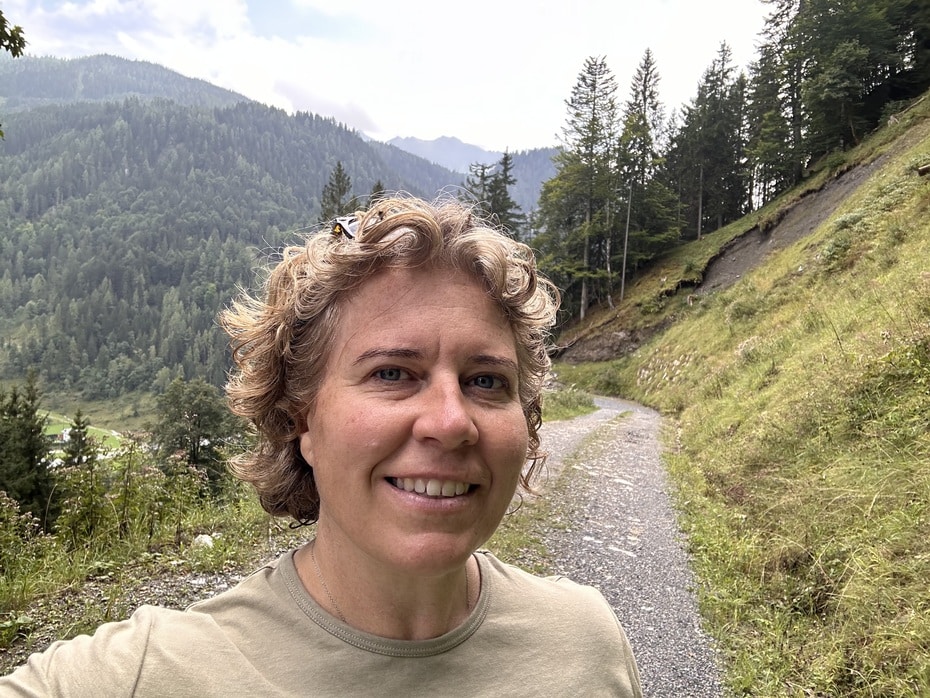 Siobhain standing in nature with a relaxed smile, founder of Solo Site Studio
